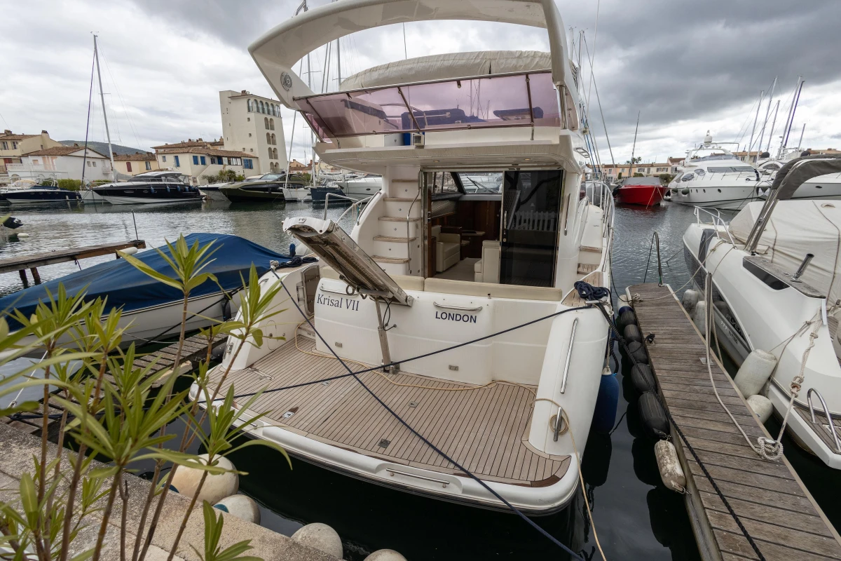 Luxury Princess 42 yacht docked in marina, 2013 model, overcast sky.