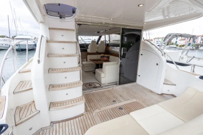 Luxurious 2013 Princess 42 yacht interior with elegant seating and wooden flooring.
