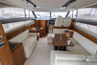 Luxurious interior of a 2013 Princess 42 yacht with elegant seating and wooden accents.