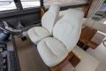 Luxurious interior seating of a 2013 Princess 42 yacht with plush white chairs.