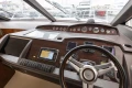 Helm of 2013 Princess 42 yacht with navigation instruments and steering wheel.