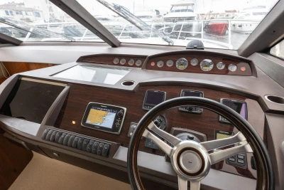 Helm of 2013 Princess 42 yacht with navigation instruments and steering wheel.