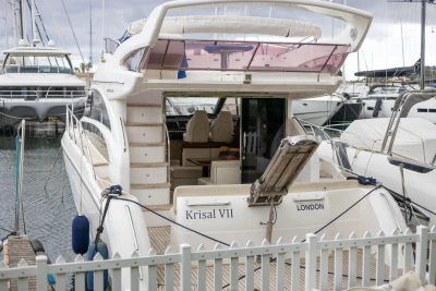 Luxury yacht Princess 42, 2013 model, docked at marina with elegant interior view.