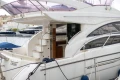 Luxury Princess 42 yacht, 2013 model, docked at marina with elegant design and spacious deck.