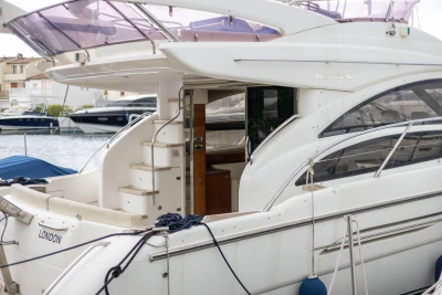Luxury Princess 42 yacht, 2013 model, docked at marina with elegant design and spacious deck.