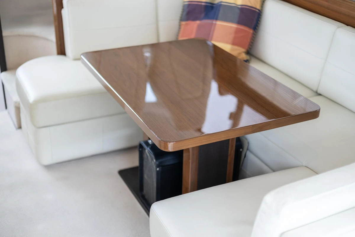Luxurious interior of 2013 Princess 42 yacht with elegant wooden table and plush seating.