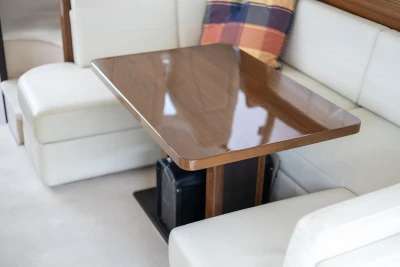 Luxurious interior of 2013 Princess 42 yacht with elegant wooden table and plush seating.
