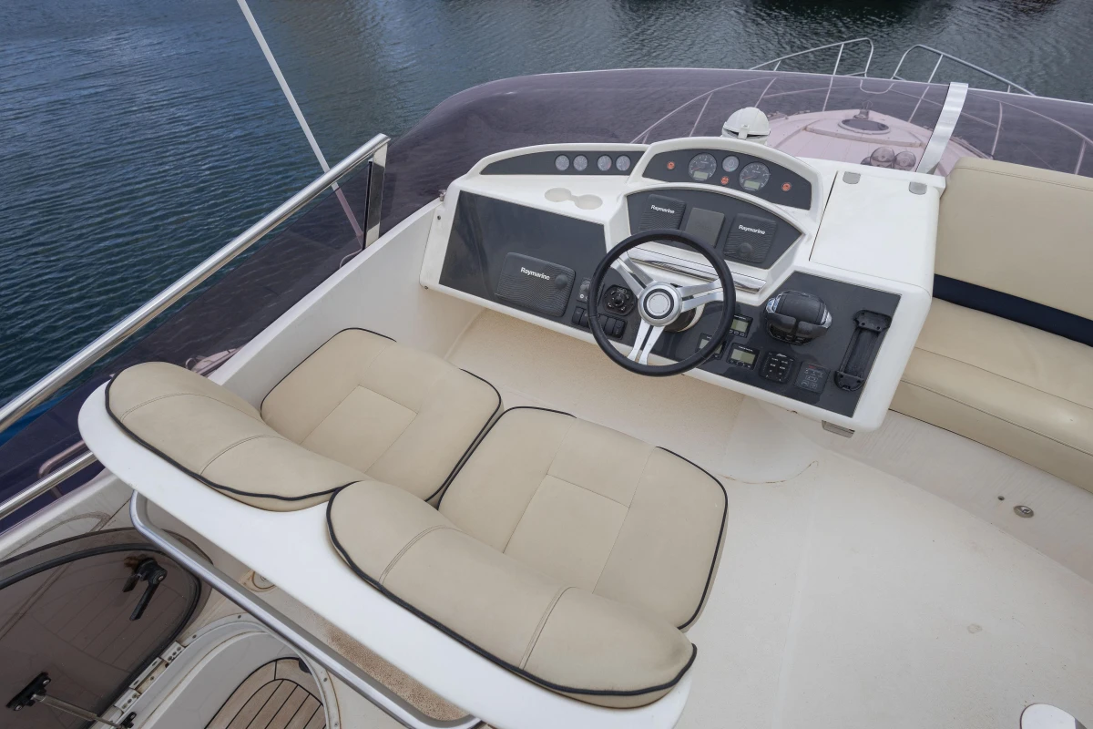 Flybridge of 2013 Princess 42 yacht with dual seating and modern controls.