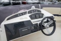Control panel of a 2013 Princess 42 yacht with steering wheel and navigation equipment.
