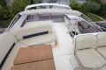 Flybridge of 2013 Princess 42 yacht with seating and table.