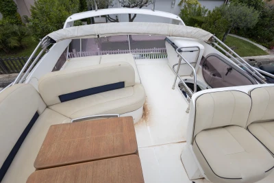 Flybridge of 2013 Princess 42 yacht with seating and table.