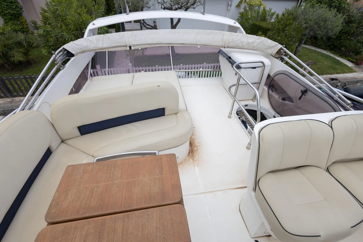 Flybridge of 2013 Princess 42 yacht with seating and table.