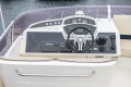 Control panel of a 2013 Princess 42 yacht with steering wheel and navigation instruments.