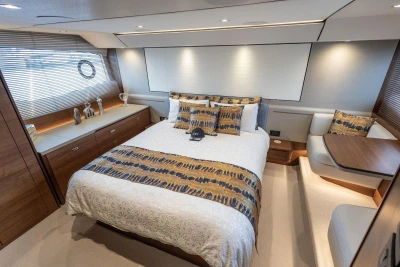 Luxurious bedroom interior of 2020 Princess F55 yacht with elegant decor and modern furnishings.
