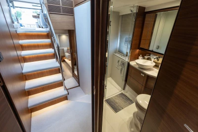 Luxurious interior of 2020 Princess F55 yacht featuring elegant staircase and modern bathroom.