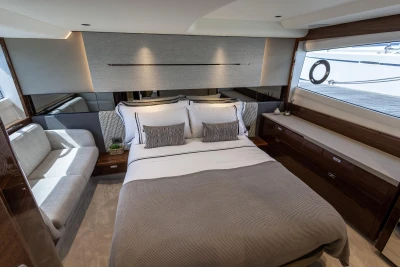 Luxurious 2023 Princess V50 yacht bedroom with elegant decor and modern furnishings.