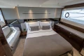 Luxurious 2023 Princess V50 yacht bedroom with elegant decor and modern furnishings.