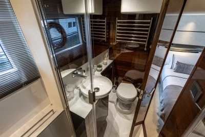 Luxurious bathroom in 2023 Princess V50 yacht, featuring modern fixtures and elegant design.