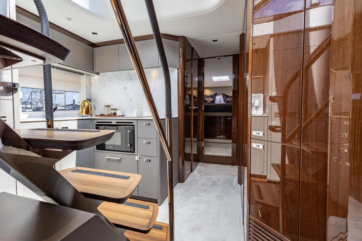 Luxurious interior of 2023 Princess V50 yacht with modern kitchen and elegant wood finishes.