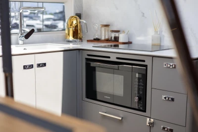 Modern kitchen in 2023 Princess V50 yacht with sleek appliances and stylish decor.