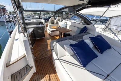 Luxurious 2015 Princess V48 Open yacht interior with elegant seating and wooden flooring.