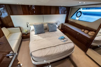 Luxurious cabin interior of 2015 Princess V48 Open yacht with elegant wood finishes.