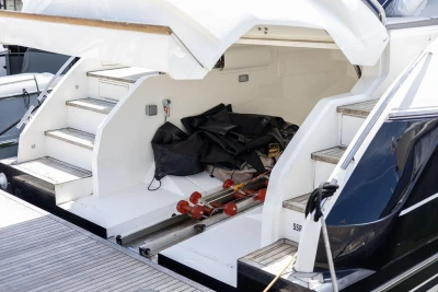 2015 Princess V48 Open yacht with open storage compartment and steps.