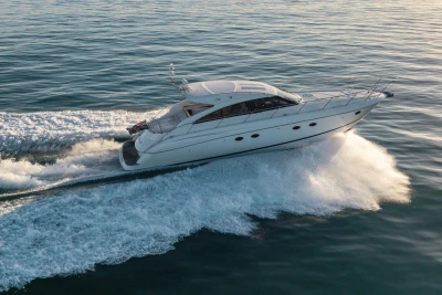 2006 Princess V53 yacht cruising on open water, creating a dynamic wake.