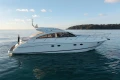 2006 Princess V53 yacht cruising on calm waters under a clear sky.