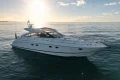 2006 Princess V53 yacht cruising on calm ocean at sunset.