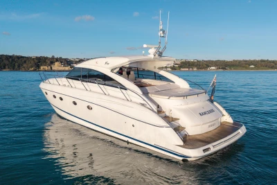 2006 Princess V53 yacht cruising on calm waters under a clear blue sky.