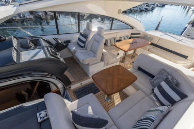 Luxurious 2006 Princess V53 yacht interior with elegant seating and wooden tables.