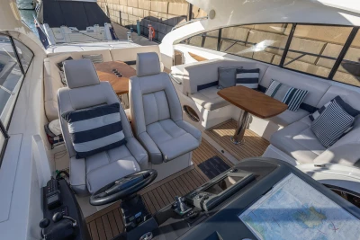 Luxurious 2006 Princess V53 yacht interior with plush seating and elegant wooden table.