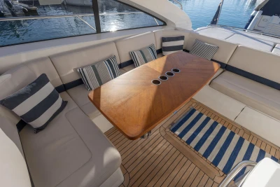 Luxurious 2006 Princess V53 yacht interior with elegant seating and wooden table.