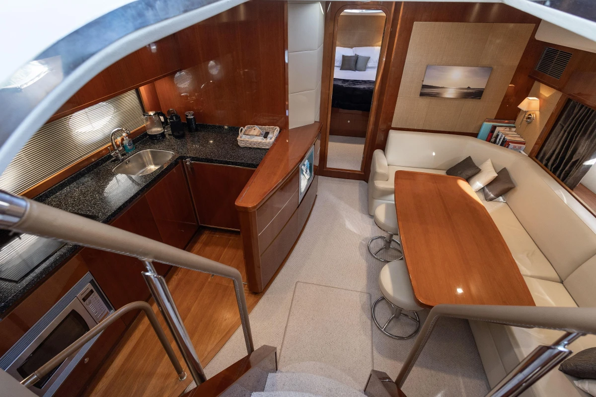 Luxurious interior of 2006 Princess V53 yacht with kitchen and dining area.