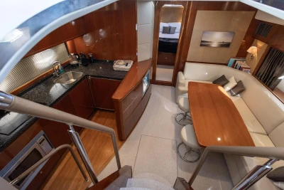 Luxurious interior of 2006 Princess V53 yacht with kitchen and dining area.