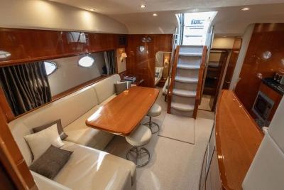 Luxurious interior of 2006 Princess V53 yacht with elegant seating and dining area.