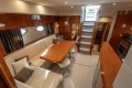 Luxurious interior of 2006 Princess V53 yacht with elegant seating and dining area.