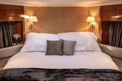 Luxurious bedroom interior of 2006 Princess V53 yacht with elegant bedding and soft lighting.