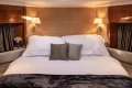 Luxurious bedroom interior of 2006 Princess V53 yacht with elegant bedding and soft lighting.