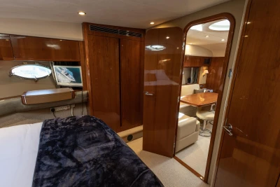Luxurious interior of 2006 Princess V53 yacht with wood finishes and cozy seating area.