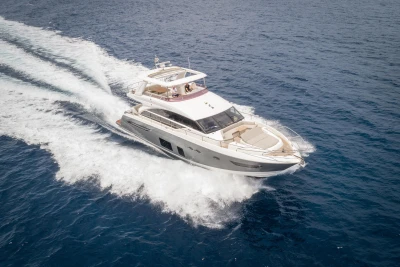 Luxurious 2015 Princess 68 yacht cruising on open sea, showcasing sleek design and elegance.