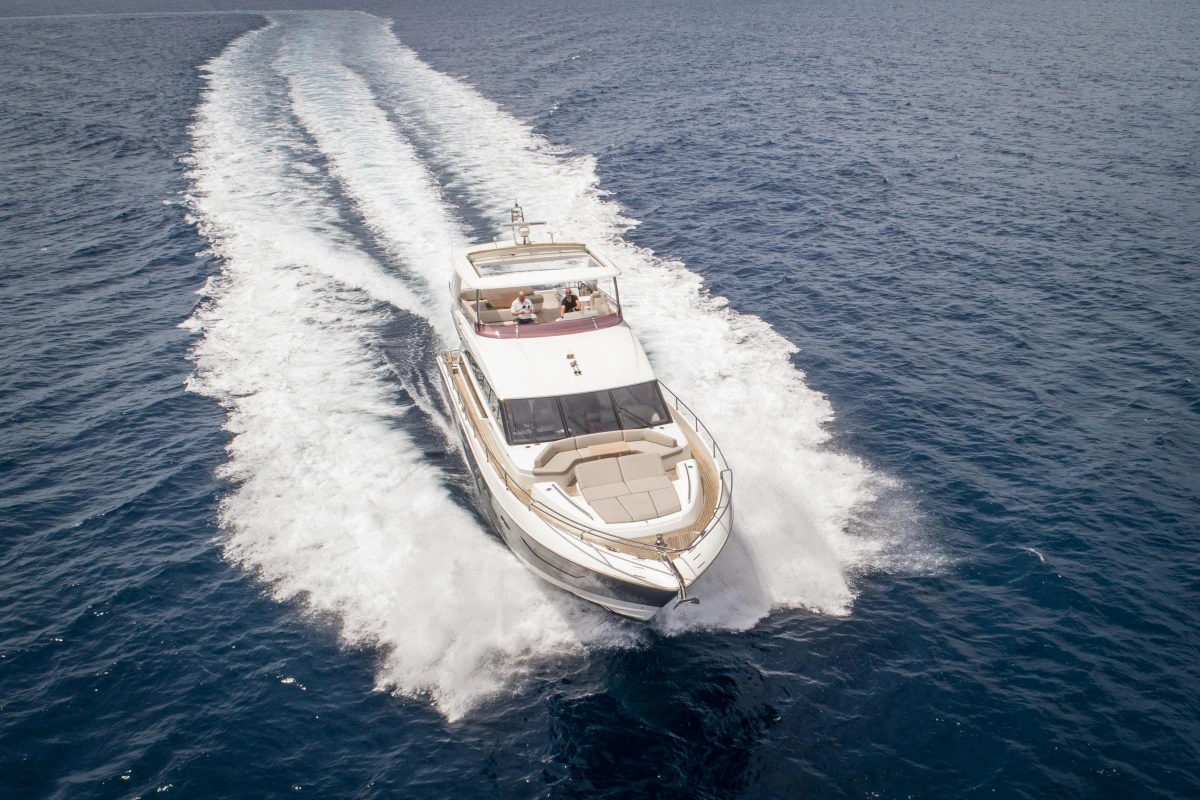Luxury Princess 68 yacht cruising on open sea, 2015 model.