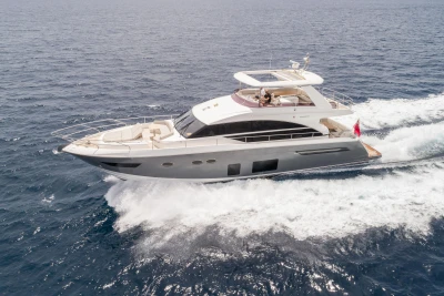 Luxurious 2015 Princess 68 yacht cruising on open sea, showcasing sleek design and elegance.