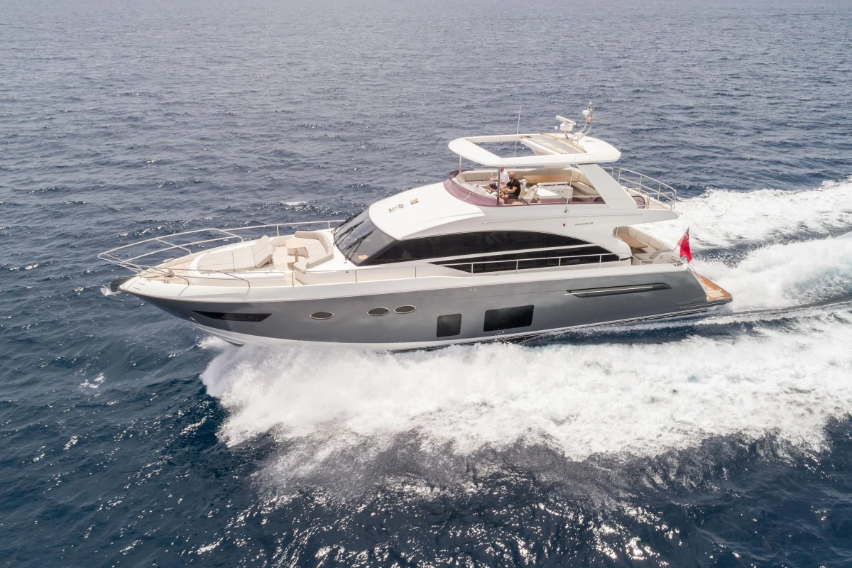 Luxurious 2015 Princess 68 yacht cruising on open sea, showcasing sleek design and elegance.