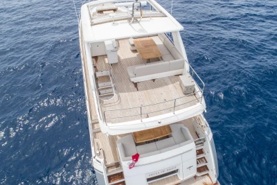 Aerial view of 2015 Princess 68 yacht on open sea, featuring spacious deck.