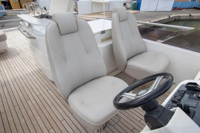 Luxury yacht helm with dual seats, Princess 68 model, 2015, featuring sleek design and controls.