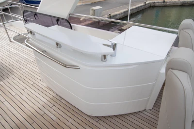 Luxurious 2015 Princess 68 yacht deck with sleek white bar and modern seating.