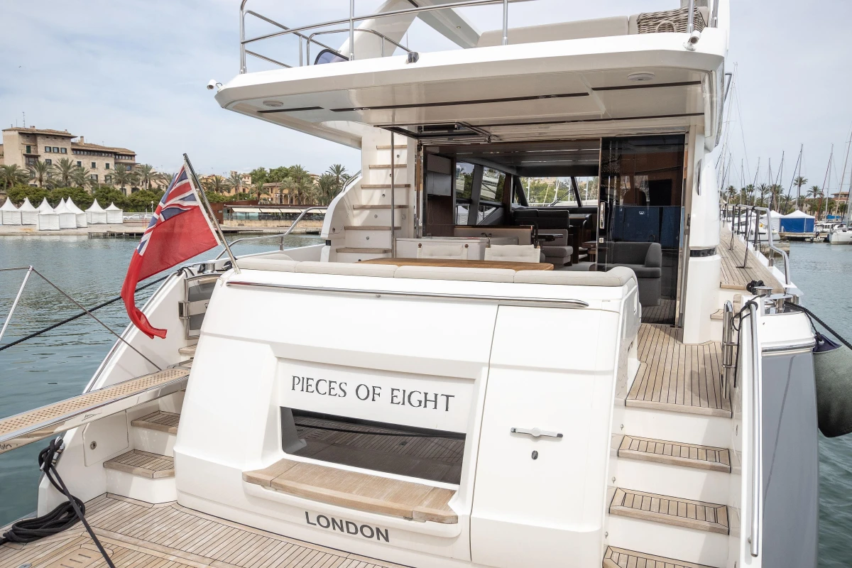 Luxury 2015 Princess 68 yacht docked, featuring spacious deck and elegant design.