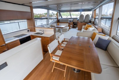 Luxurious interior of 2015 Princess 68 yacht with modern furnishings and panoramic windows.